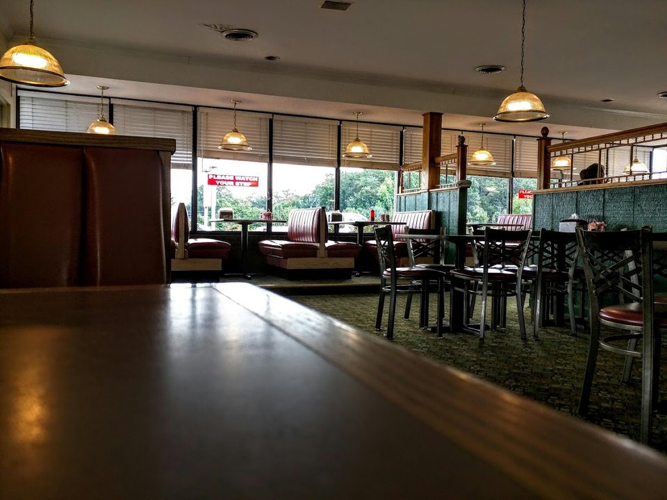 Casual family restaurant dining room with simple tables.
